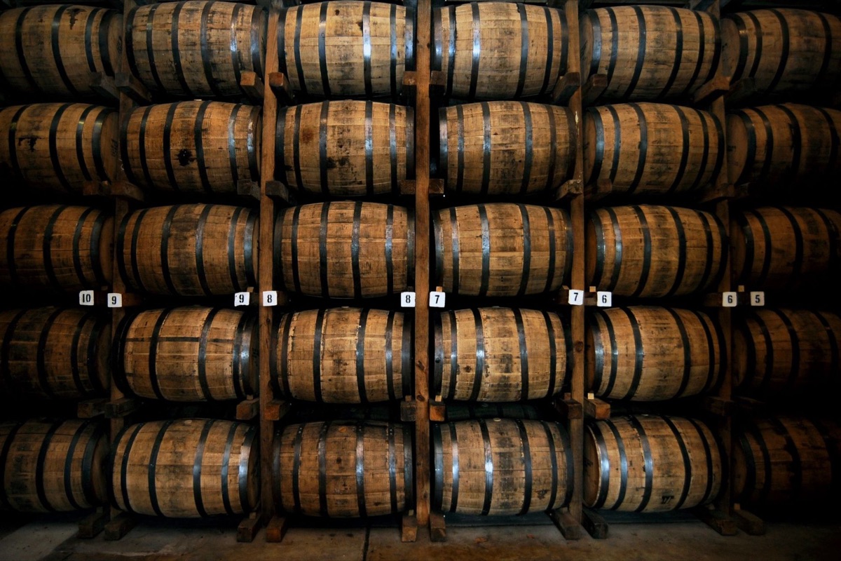 Bourbon barrels aging on numbered wooden racks
